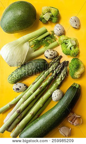 Fresh Organic Vegetales For Preparing Healthy Meal. Concept Green On Yellow. Flat Lay. Overhead.