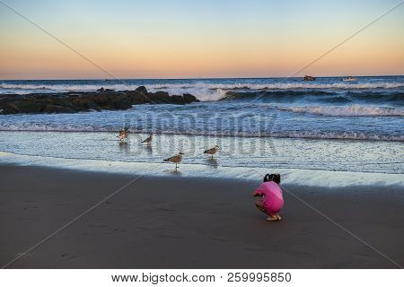 Avon By The Sea, New Jersey-september 16: A Young Girl Looks For Shells On The Beach At Sunset On Se