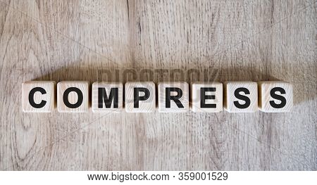 Compress Text Word On Wooden Cubes On Wooden Background