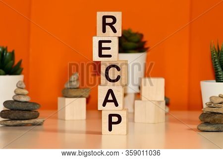 Recap Word From Wooden Blocks On Desk