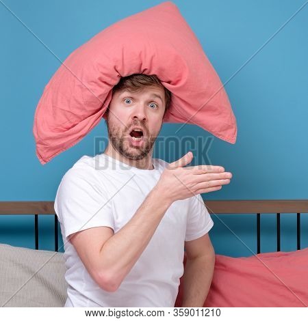 Cauacsian Young Man With Pillow On Head Lying In Bed And Screaming Being Alone Stressed Because Of Q
