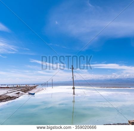 Salt Lake landscape with blue boat, named Chaka Salt Lake, is located in Qinghai Province, China.
