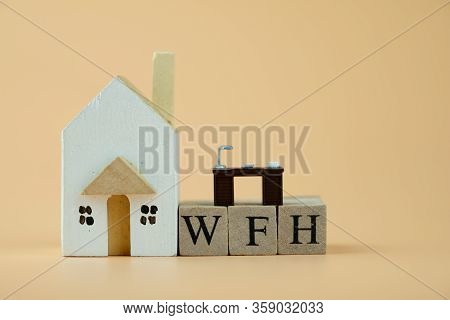 Wooden Home With Miniature Office Table On Wooden Blocks Word Of Wfh : Work From Home. Comfortable P