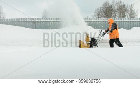 Man Cleans Snow With A Snow Thrower Goes Right To Left