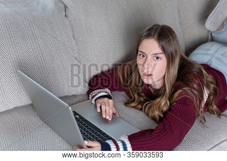 Teen girl upset by being monitored by her parents of her online screen time. Concept image of how parents should monitor how their child spend their time online