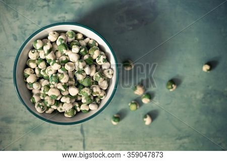A bowl of wasabi peas, a spicy Japanese savory snack of dried green peas with a wasabi horseradish coating.