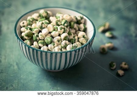 A bowl of wasabi peas, a spicy Japanese savory snack of dried green peas with a wasabi horseradish coating.