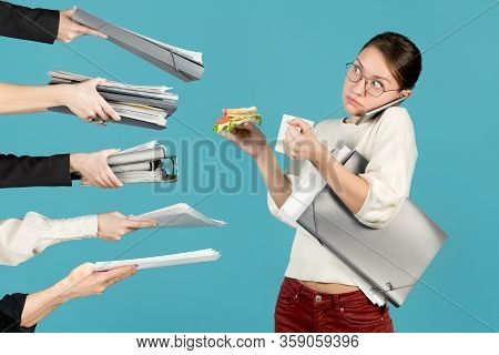 Shocked Office Employee Looks Away While Holding Coffee And A Sandwich. Colleagues And Superiors Han