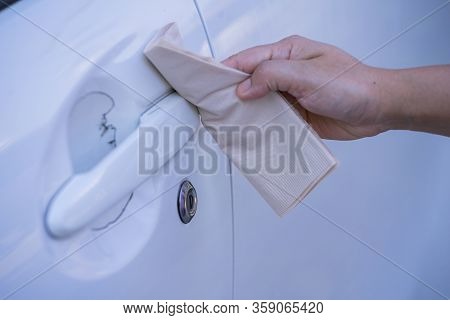 Asian Women Spry Soap And Clean Car Door Handle With Napkin.