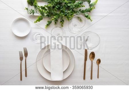 Elegant Table Setting, White Plates, Gold Cutlery, Wine Glasses And Centrepiece . Tableware And Deco
