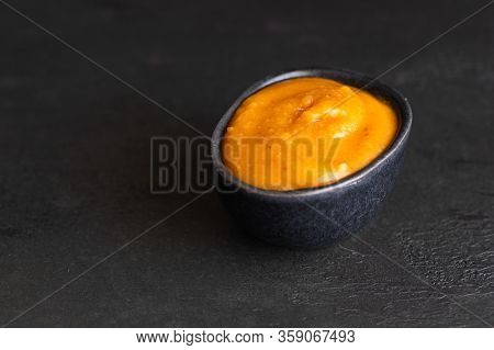 Almogrote, Famous La Gomera Cheese Paste, In Black Ceramic Bowl On Background. Its Appetizer In Many