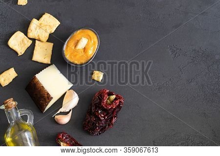 Almogrote , Cheese Paste With Their Ingredients Hard Cheese, Peppers, Olive Oil And Garlic On Black 