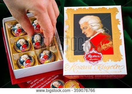 Tambov, Russian Federation - February 14, 2020 Woman Hand Taking Mozart Candy From Open Candy Box. G