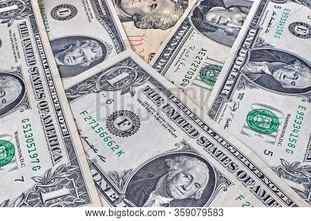 The Background Of Us Dollar Bills Is Scattered On The Table