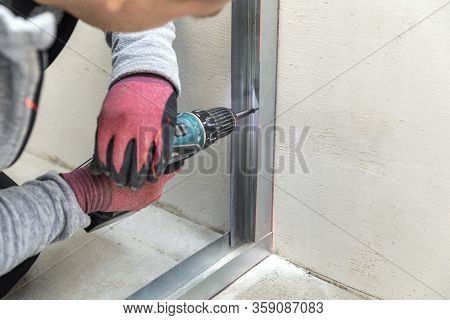 Man Fasten Metal Profile Frame To The Wall For Draywall Bulkhead