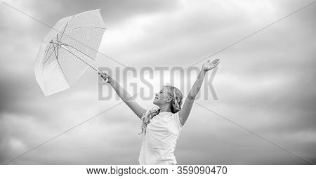 Feeling Dry And Protected. Fall Kid Fashion. Child At Cloudy Sky. Rain Protection. Happy Small Girl 