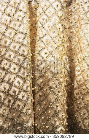 Wedding Dress Fabric Texture Background. Golden And Ivory Silk Dress With Beads, Pearls, Sparkles An