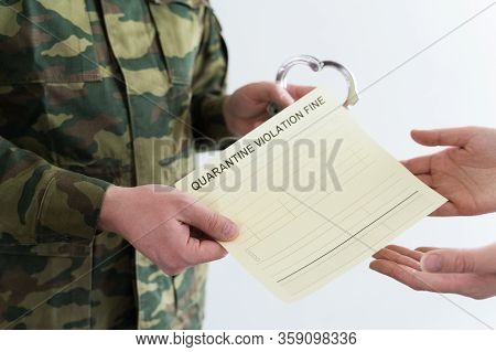Police Officer With Handcuffs In Khaki Colored Uniform Stops People On The Street For Violating Rule