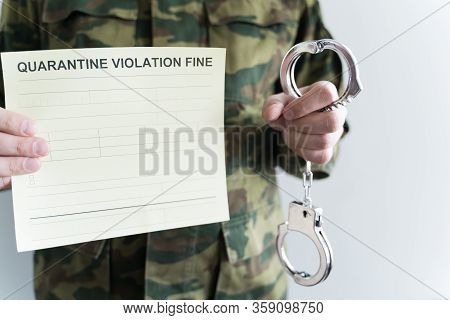 Police Officer With Handcuffs In Khaki Colored Uniform Stops People On The Street For Violating Rule