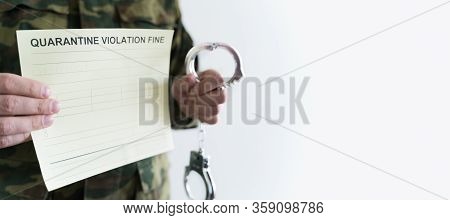 Police Officer With Handcuffs In Khaki Colored Uniform Stops People On The Street For Violating Rule