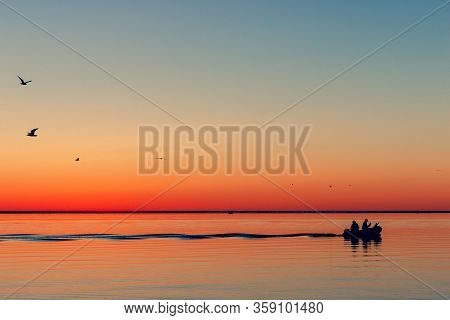 Fishing Boat Leaves The Bay At Sea For Fish In The Fall At Dawn. Nida, Neringa, Lithuania