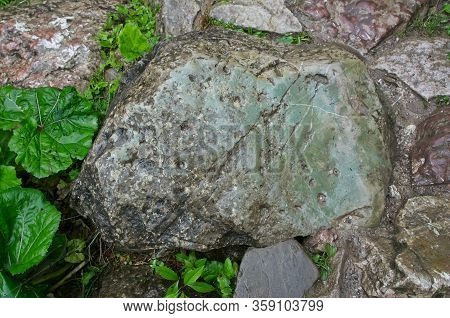 Wet Green And Gray Rocks. Limestone Is A Carbonate Sedimentary Rock That Is Often Composed Of The Sk