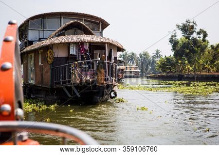 Alapuzha, Kerala, India-february 4, 2019. A Pleasure Boat And House-boat On The Seaweed-covered Rive