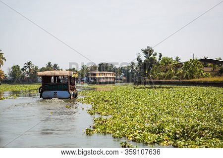 Kerala`s Landmark Is A Pleasure Boat And House-boat On The Seaweed-covered River Channels Of Allapuz