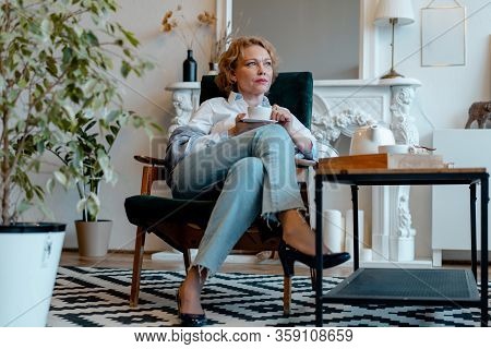 Stay Home. Isolation And Quarantine. Beautiful Senior Woman Drinking Tea At Living Room Alone.