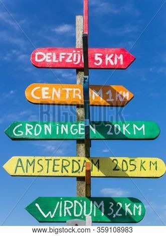 Colorful Signpost Pointing To Various Cities In Appingedam, Netherlands