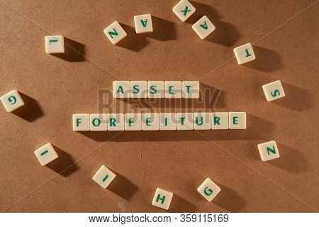 Asset forfeiture word made of square letter word on brown background.