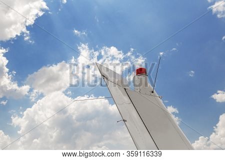 Plane Tail Against Blue Sky. Tail Section Of Small Aircraft