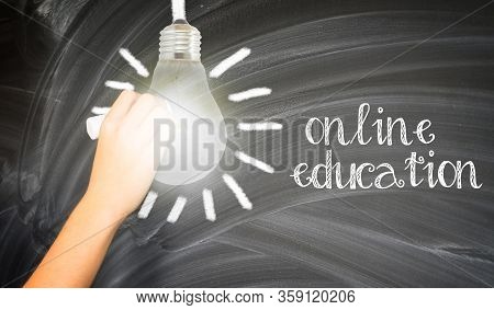 Hand With Chalk Writting On School Blackboard Online Education