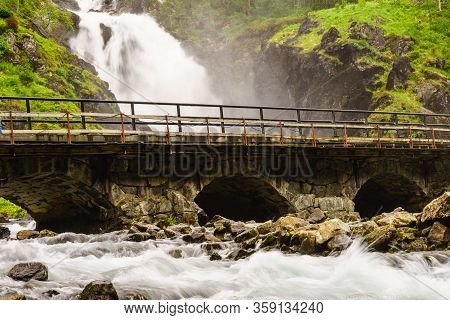 Norwegian Landscape. Waterfall Latefoss Latefossen With Stone Arched Bridge Road, Odda Hordaland Nor