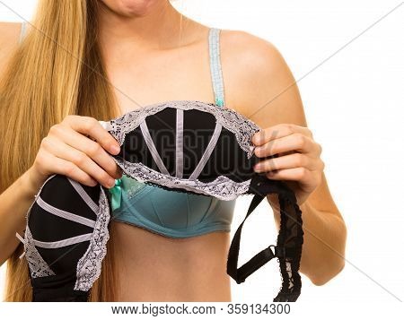 Young Blonde Woman Trying On Black Bra With White Lace. Bra Has Removed The Underwire. Bosom Concept