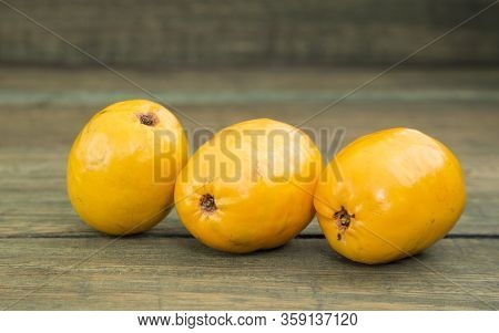Spondias Purpurea - Delicious Tropical Fruit. Wood Background