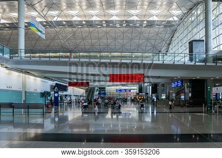 Hong Kong, China - 2020: Hong Kong International Airport, Arrivals Hall. People With Baggage In The 