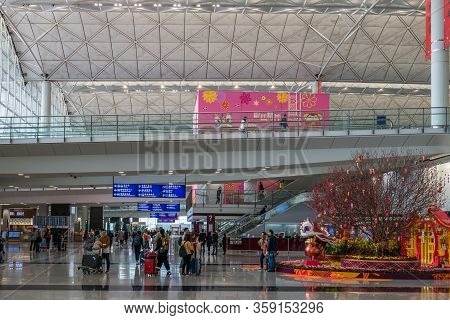 Hong Kong, China - 2020: Hong Kong International Airport, Arrivals Hall. Passengers With Suitcases, 