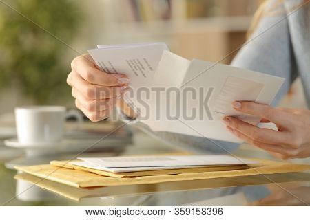 Close Up Of Girl Hands Opening An Envelope With A Letter Inside On A Desk At Home