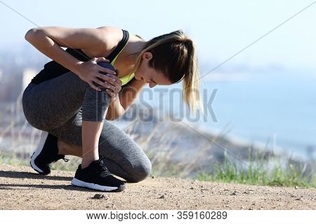 Injured Runner Complaining Alone Suffering Knee Ache On The Ground In City Outskirts