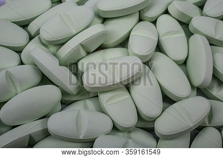 Macroshot. Multi-colored Pills Lie On The Table Background Image. Drugs, Painkillers, Colds And Othe