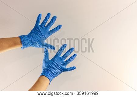 Hands In Blue Medical Glove On White Background. Protection Against Pandemics, Covid-19