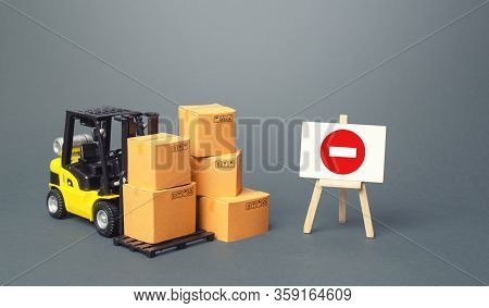 Forklift With Boxes And An Easel With Restriction Sign. Restrictions On Export Of Scarce And Medical