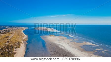 Industrial City In Summer. Low Tide At Sea