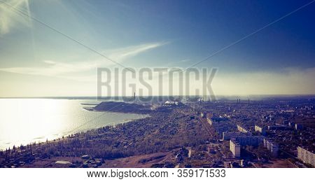 Industrial City In Summer. On The Horizon, A Metallurgical Plant Near The Sea