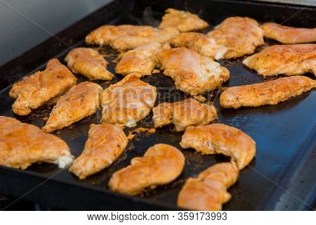 Many Chicken Breast Grilling On Gas Grill Outdoor.