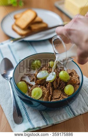 Breakfast Cereal With Grapes And Toast On Butter