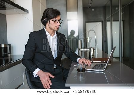 Businessman Works From Remote At House With A Laptop Due To Coronavirus Quarantine.