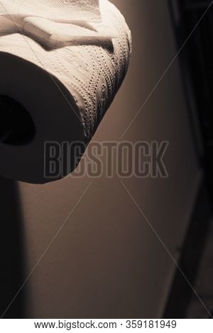 Dramatic Close Up Of Toilet Paper Supply
