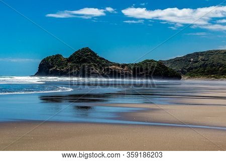 Sandy Beaches, Cliffs And Rolling Water On Bethels Beach. Auckland, New Zealand